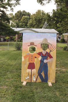 an easel painted to look like two people holding gardening tools