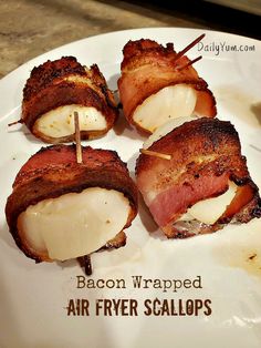 bacon wrapped air fryer scallops on a white plate