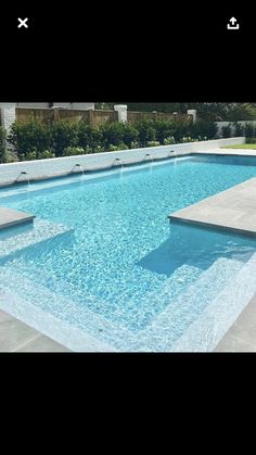 an empty swimming pool in the middle of a yard