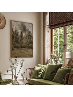 a living room filled with furniture and a painting on the wall above it's windows