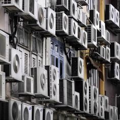 many air conditioners are stacked on top of each other