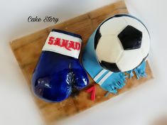 a cake that is shaped like a soccer ball and boot with the name sandad on it