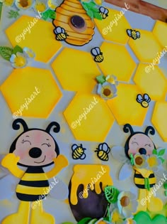 bees and honeycombs are on the table with flowers, leaves and other decorations