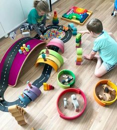 two children playing with toys on the floor