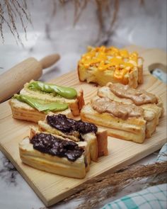 a wooden cutting board topped with different types of food