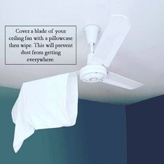 a ceiling fan with a white cloth hanging from it's blades and the words cover a blade of your ceiling fan with a pillow when wipe this will prevent dust from getting everywhere