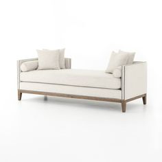 a white couch sitting on top of a wooden frame