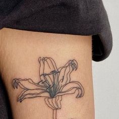 a woman's thigh with a flower tattoo on her left side ribcage