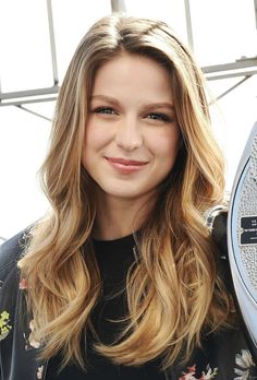 a close up of a person with long hair and a radio in front of her