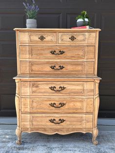 an old dresser with some flowers on top