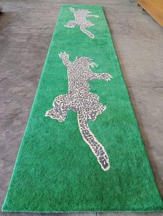 a long green rug with an image of a person on it