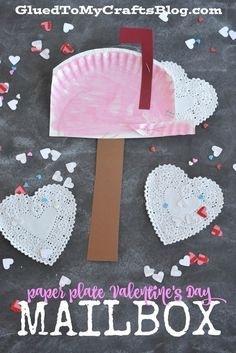 a paper plate valentine's day mailbox craft with hearts on it and a piece of cardboard