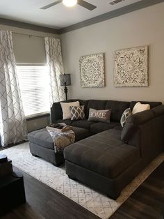 a living room filled with furniture and pillows on top of a white carpeted floor