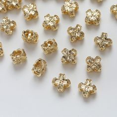 gold plated metal beads on a white surface