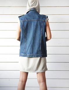 Unisex vintage blue denim sleeveless jacket casual biker style vest. Front button closure, two side pockets, shoulder tabs, no lining. Material is 100% cotton. Made in Britain. Size M on tag. Measured laying flat (please double for circumference): 25'' / 63.5 cm long 20.5'' / 52 cm armpit to armpit 19'' / 48 cm waist Great vintage condition. Sleeveless Cotton Denim Vest With Pockets, Sleeveless Denim Jacket For Spring Streetwear, Fitted Cotton Denim Vest With Pockets, Sleeveless Denim Vest With Pockets For Streetwear, Sleeveless Denim Vest For Spring Streetwear, Cotton Medium Wash Vest Outerwear, Blue Cotton Denim Vest With Pockets, Trendy Cotton Denim Vest With Pockets, Sleeveless Denim Blue Cotton Outerwear