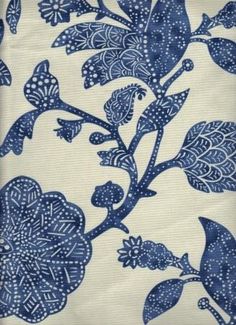 a blue and white pillow with flowers on it