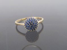 Vintage 18K Solid Yellow Gold Blue Sapphire Ball Pave Ring...Marked 18K...Total of weights 1.8grams... Size 6....With 48 Blue Sapphires 1MM ( .005ct x 48 = .28ct ) Measure of Face 8MM...It's in very good condition. Blue Sapphire Ring In 14k Gold, Blue 14k Gold Cluster Ring, Gold Cluster Sapphire Promise Ring, Blue Diamond Promise Ring With 17 Jewels, Blue Cluster Jewelry Hallmarked, Blue Cluster Jewelry With Hallmark, Blue 14k Gold Cluster Ring With Round Cut, 14k Gold Blue Cluster Ring With Round Cut, Gold Sapphire Cluster Ring