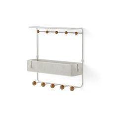 a white wall mounted shelf with three balls on the bottom and two shelves above it