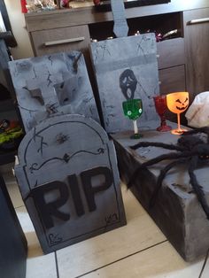 two halloween bags sitting on top of a floor next to each other with faces painted on them