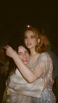 two women hugging each other at a party