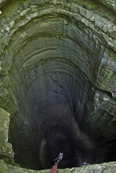 a man standing in the middle of a cave