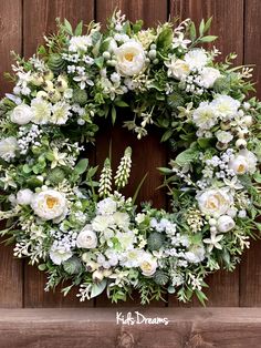 a wreath with white flowers and greenery