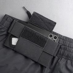 a cell phone is in the pocket of a pair of pants that are attached to a belt