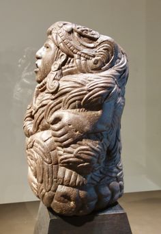 an ancient sculpture on display in a museum