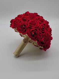 a bouquet of red roses sitting on top of a table