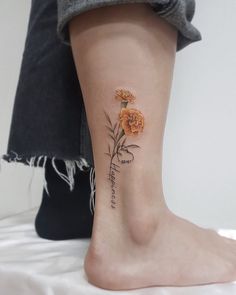 a person with a flower tattoo on their foot