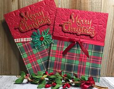 two red and green christmas greeting cards with holly on the side, one has a bow