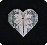 an origami heart made out of money