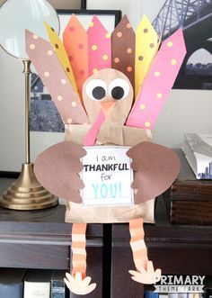 a paper turkey holding a sign that says i am grateful for you