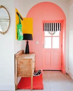 an entryway with pink walls and yellow accents