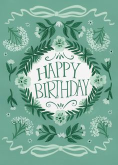 a happy birthday card with green leaves and flowers on the front, surrounded by white daisies