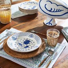 a table set with plates, glasses and utensils