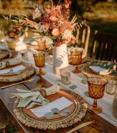 the table is set with plates and place settings