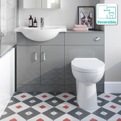 a white toilet sitting next to a bathroom sink