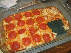 a large pepperoni pizza sitting on top of a pan