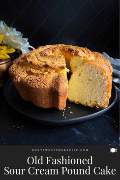 an old fashioned sour cream pound cake on a black plate