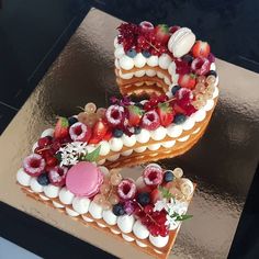 there is a cake with fruit on it that has the letter s made out of frosting