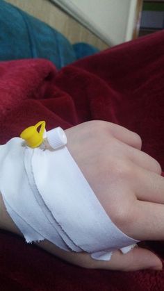 a hand wrapped in bandages with a yellow rubber duck on it's thumb and finger