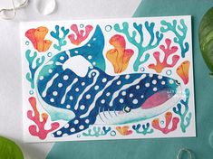 a card with an image of a blue whale surrounded by corals and seaweed