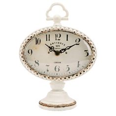 an old fashioned white clock with numbers on the face and hands is shown against a white background