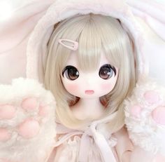 a doll with long blonde hair and big eyes wearing a white bunny ears outfit is posed for the camera