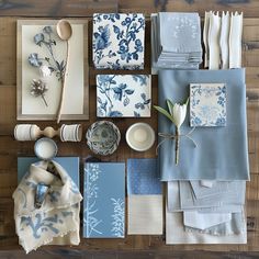 the table is covered with blue and white dishes, napkins, and other items