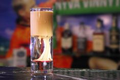 a glass filled with liquid sitting on top of a counter