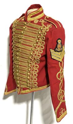 Men’s Ceremonial General Red  Jacket With Front gold Braiding with Chevrons and Royal hand Embroidery Badge This is a heavy cotton Military style jacket, it is fitted well tailored made jacket with brass buttons and lots of details on sleeves and collars and jacket is fully lined with black satin.Please note Chevrons and hand embroidery Badge will be suppled  but need to be secured ,both needs to hand stitching upon receiving.Please refer to photos.Jacket is available 3 sizes to fit in 42”, 44”a Fitted Ceremonial Outerwear For Festivals, Fitted Red Outerwear For Ceremonial Occasions, Fitted Red Ceremonial Outerwear, Traditional Red Costume Outerwear, Red Ceremonial Winter Outerwear, Red And Gold Armor, Ceremonial Red Winter Outerwear, Gold Tailored Suit-collar Outerwear, Luxury Men's Outerwear With Gold Embroidery