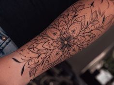 a person with a flower tattoo on their arm