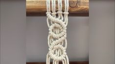 a white rope hanging from a wooden beam